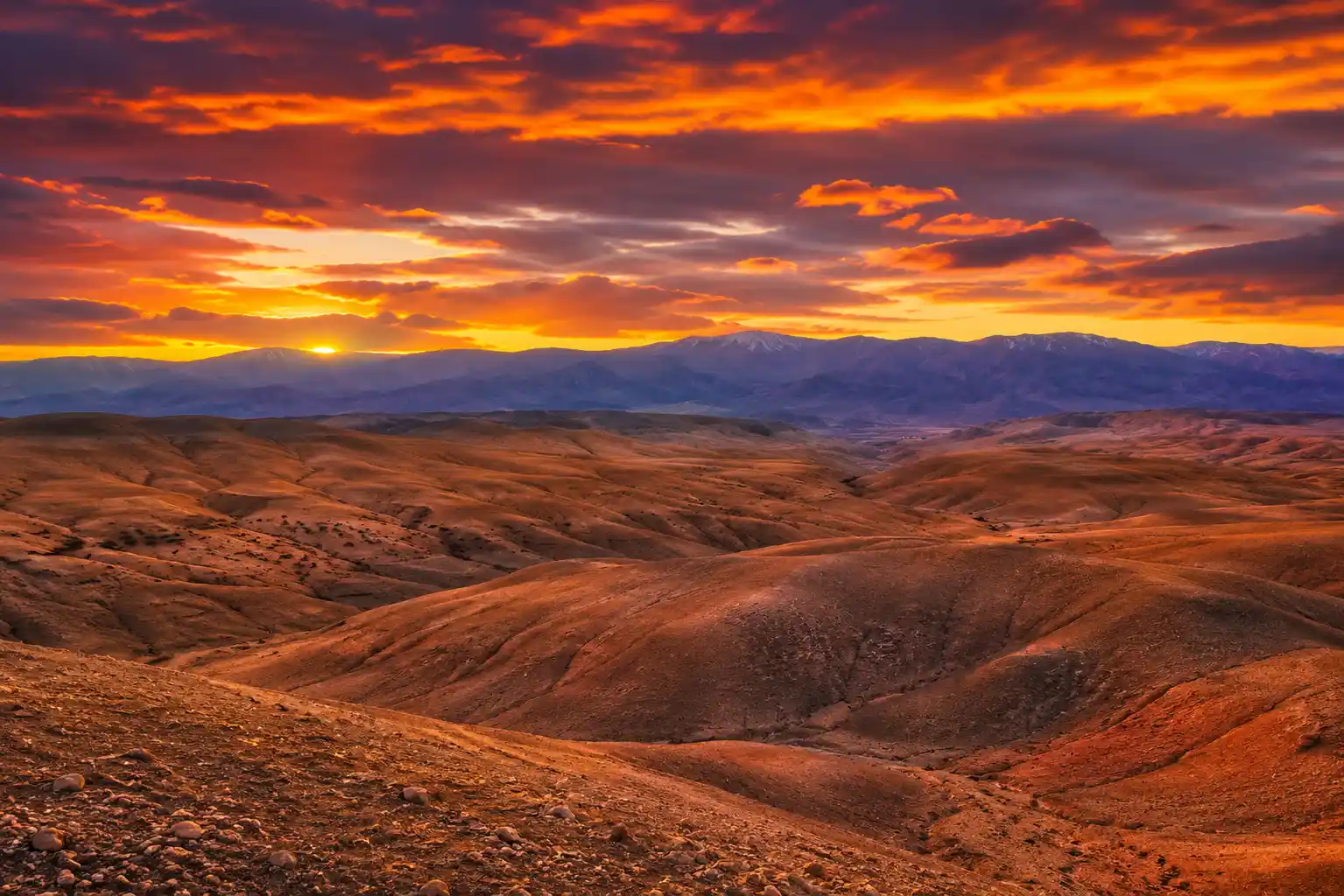 Golden sunset over the Agafay Desert landscape near Marrakech