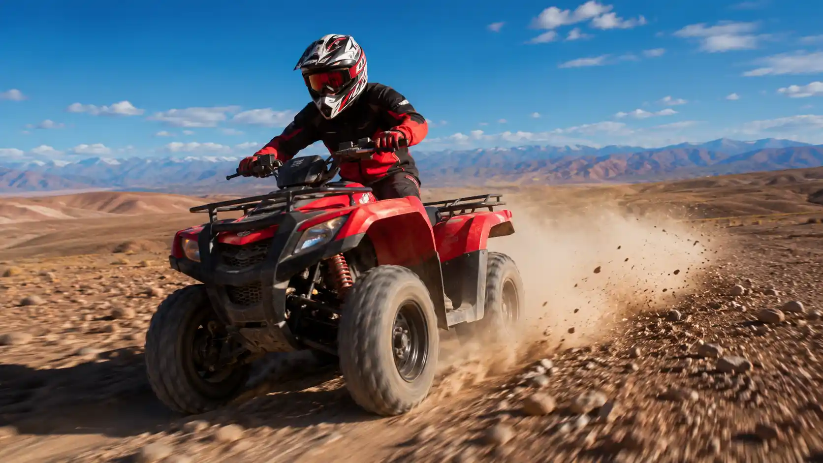 Quad biking in the Agafay Desert with rider kicking up dust near the Atlas Mountains